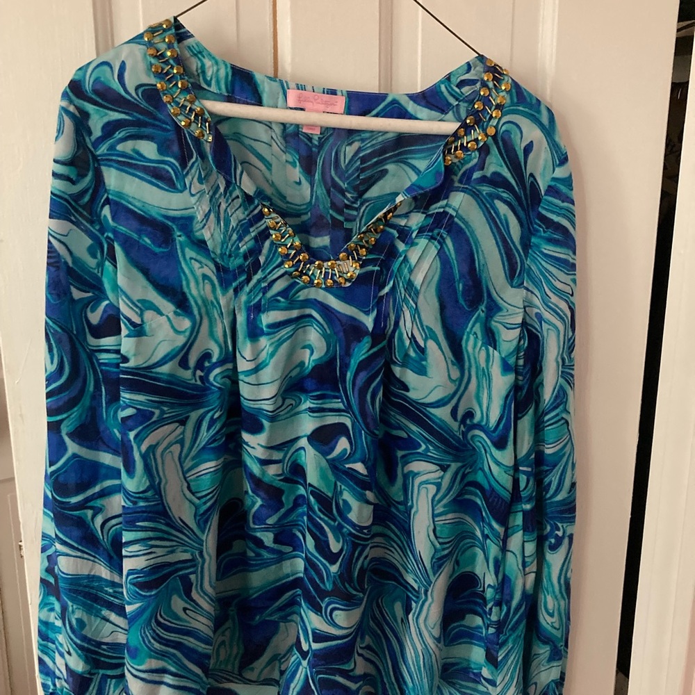 Silky tunic top with gold embellishment a neckline.